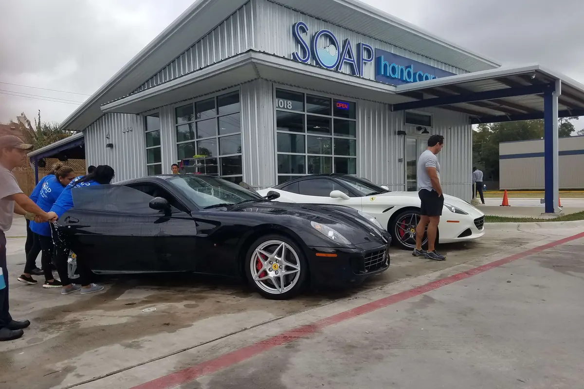 SOAP Hand Car Wash storefront with cars being hand washed